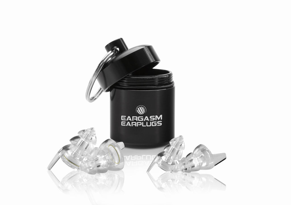 Eargasm Earplugs branded carrying case, with a pair of the Standard size earplugs with the transparent filters pre-inserted, and a pair of the small size shells in front of it.